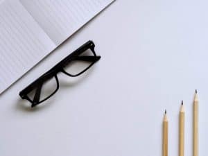 photo of pencils and eyeglasses on desk
